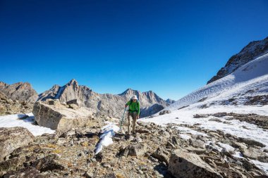 hiker in mountains on beautiful rock background