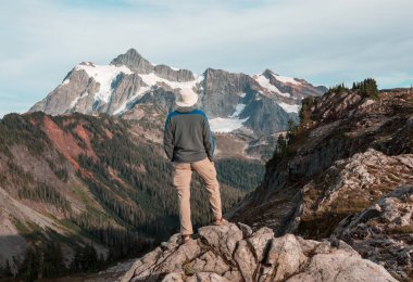 hiker in mountains on beautiful rock background