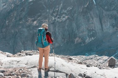 hiker in mountains on beautiful rock background