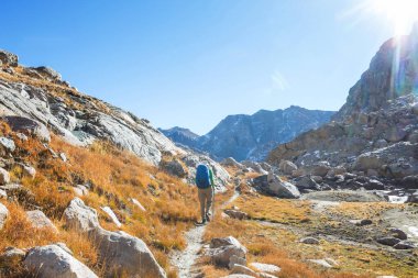 hiker in mountains on beautiful rock background