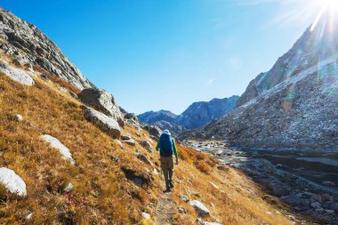 hiker in mountains on beautiful rock background