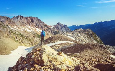 hiker in mountains on beautiful rock background