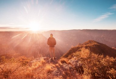 Tourist at sunrise in mountains Barrancas del Cobro, Mexico