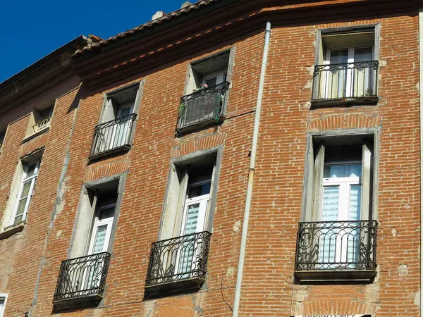 Facade of old european houses with windows and balconies decorated