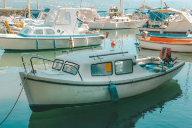 Fishing dinghy boats moored in small marina in town of Lovran, Croatia. Selective focus.