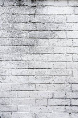 Vertical shot of old white painted rustic brick wall facade as background