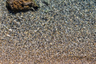 Pebbles in the sea as natural background, top view