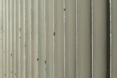 Old cast iron household central heating radiator in living room, closeup with selective focus