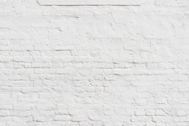 Arka plan olarak tuğla desenli beyaza boyanmış eski alçı duvar