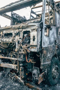 Semi truck engulfed by fire flames after traffic accident is burned and damaged, selective focus