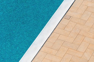 Outdoor swimming pool water as abstract summer season background, high angle view