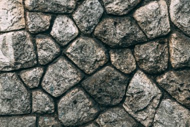 Old stone wall facade pattern as background. Detail from the town of Lovran in Croatia.