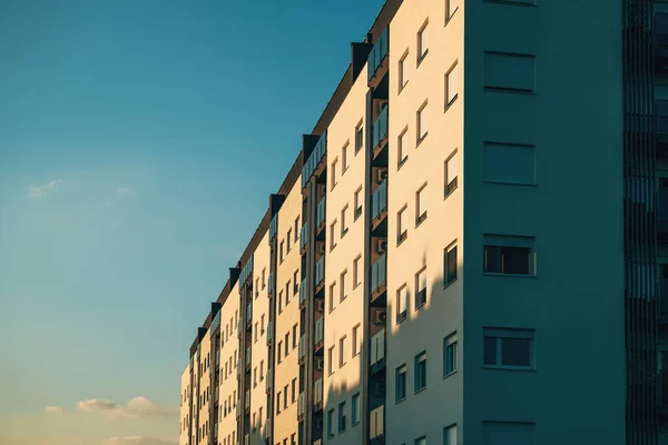 日没の太陽 低い角度の眺めによって照らされる西側に直面する窓が付いている住宅のマンションのアパートの建物 — ストック写真