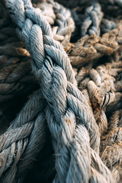 Old worn frayed ship ropes as background, selective focus
