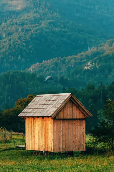 Wooden garden house in Julian Alps landscape, typical farm shed in Slovenia, selective focus