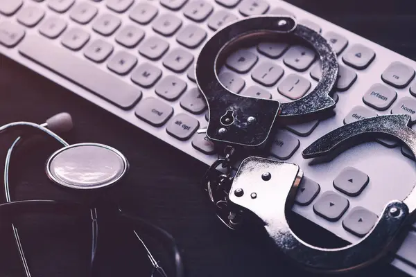 Stethoscope Handcuffs Computer Keyboard Criminal Activity Healthcare Industry Concept Selective — Stock Photo, Image