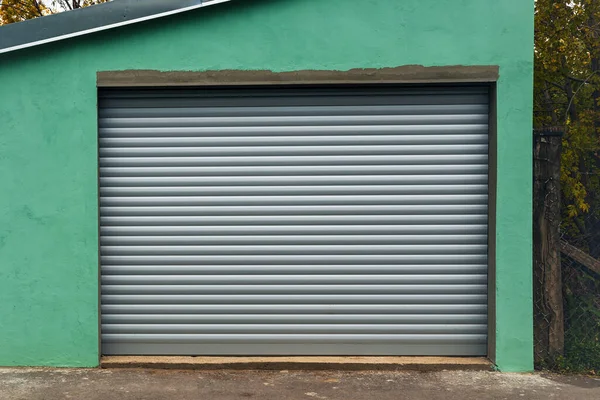 Old garage with new shutter door, copy space included