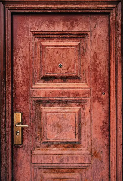 Hasarlı kapı kolu ve dikey görüntüsü olan eskimiş bir daire.