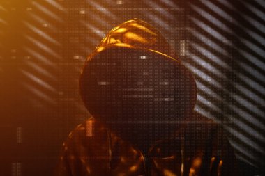 Karanlık odada sarı kapüşonlu ceket giyen tanımlanamayan bilgisayar korsanı, görüntüyü gizleyen onaltılık kod, seçici odaklanma