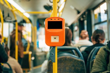 Bus ticket validator equipment in public bus, selective focus clipart