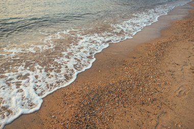 Vrasna beach in summer, Aegean sea waves at the shoreline, selective focus clipart