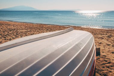 White lifeboat at Aegean sea shoreline in Strymonian gulf, selective focus clipart