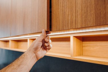 Erkek eli mutfak dolabını açıyor, seçici odak noktası