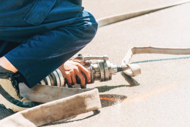İtfaiyeciler su hortumunu yerleştiriyor, seçici odaklanma