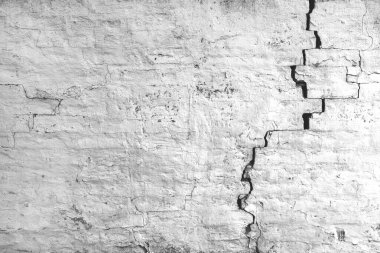 Görünür aşınma ve doku ile çatlak ve hasarlı eski tuğla duvar. Yıpranmış şehir modeli,