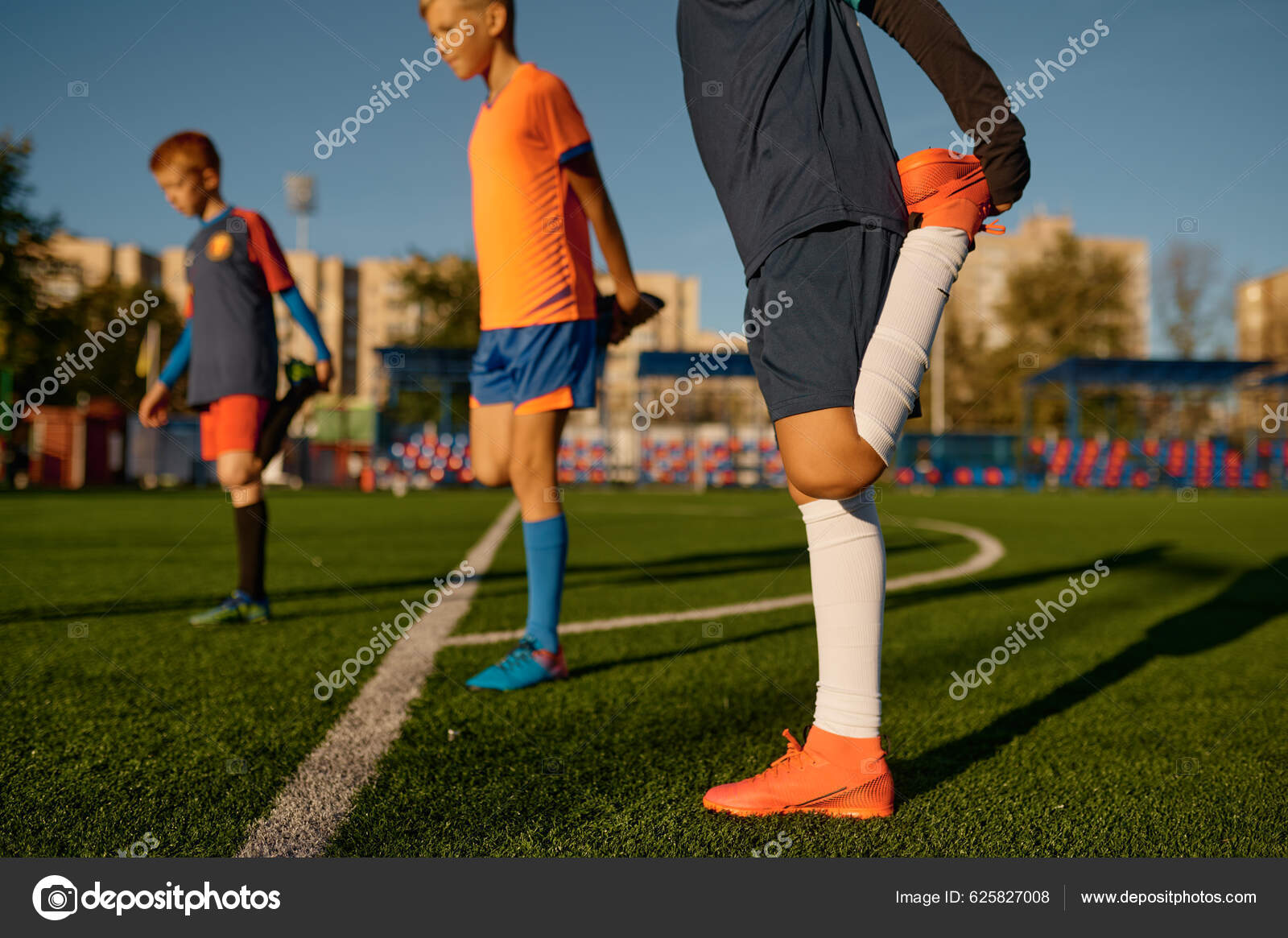 Young Football Players Doing Warm Workout Stretching Legs Soccer