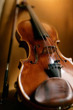 Violin musical instrument left by musician on chair. Violinist equipment for music performance. Closeup view