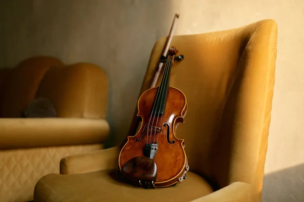 Violin musical instrument left by musician on chair. Violinist equipment for music performance