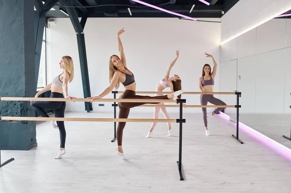 Young Elegant Women Dancers Stretching Legs Practicing Ballet Movement Barre — Fotografia de Stock