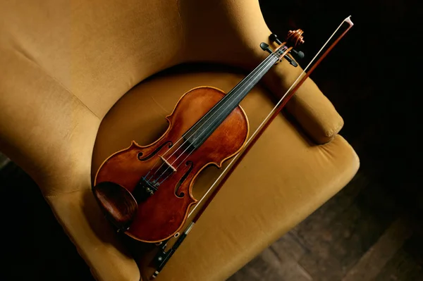 Violin musical instrument on the chair. Violinist equipment for music performance