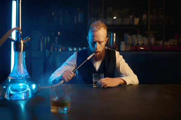 Portrait Lonely Bearded Man Sitting Table Smoking Hookah While Drinking — Fotografia de Stock