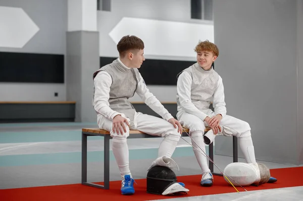 Two Young Fencers Talking While Sitting Bench Teenage Swordsman Resting — Stock Photo, Image