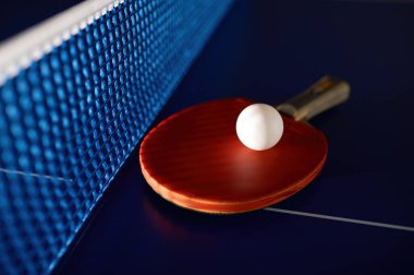 Masa tenisi ekipmanları mavi masa tenisi masasında şebeke ağlı. Yeteneklerini geliştirmek için spor kulübü ve eğitim sınıfı