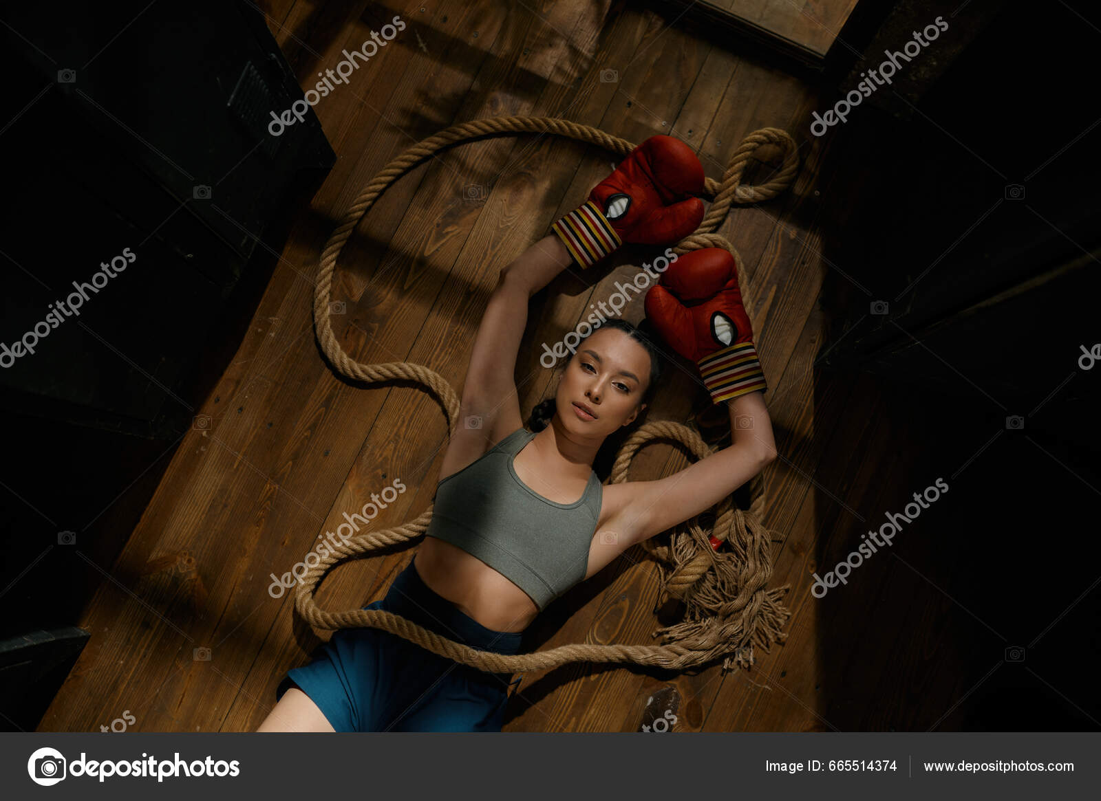Pretty Female Boxer Knocked Out Laying On The Floor Stock Photo