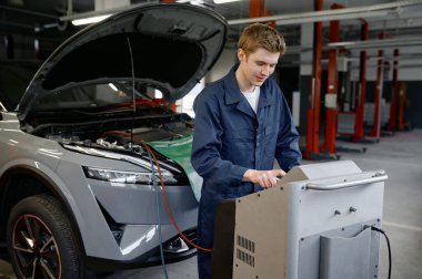 Otoparktaki tamirci klima ya da klima kontrol ve onarım yapıyor. Profesyonel oto servis istasyonu.
