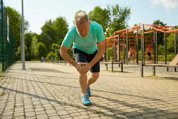 Senior Sportsman Suffering Knee Having Injury Jogging Workout Sprain Ligament — Stock Photo, Image
