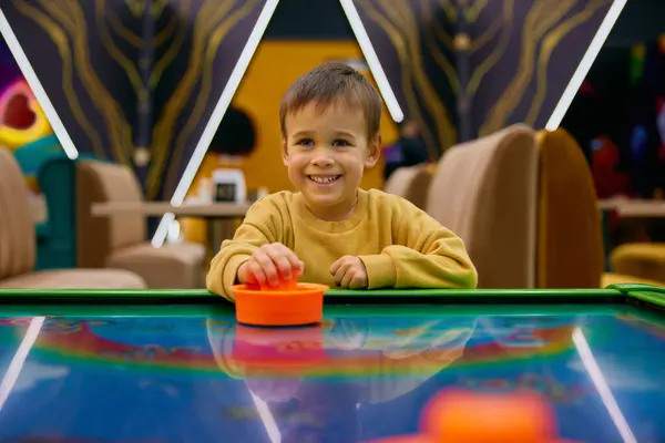 Active Little Boy Child Playing Air Hockey Entertainment Center Portrait Stock Picture