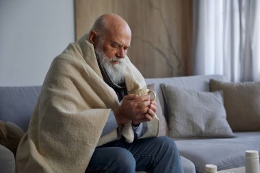 Hasta, zayıf, son sınıf öğrencisi, battaniyeli omuzlarıyla kanepede oturmuş çay içmekten rahatsız oluyor. Ateşli ya da grip virüsü kapmış bir büyükanne.