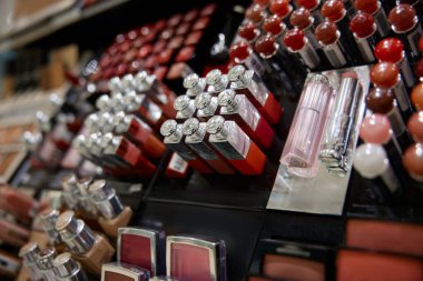 An elegant display showcasing various lipsticks along with an array of other cosmetics and beauty products