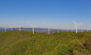 Fransız tepelerindeki rüzgâr türbinlerinin tarlaları Herault 'ta mavi bir gökyüzünde