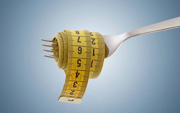 Fork with yellow measuring tape on light blue background. Concept of proper, balanced nutrition diet.