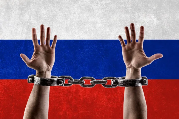 Shackled hands against Russian flag background