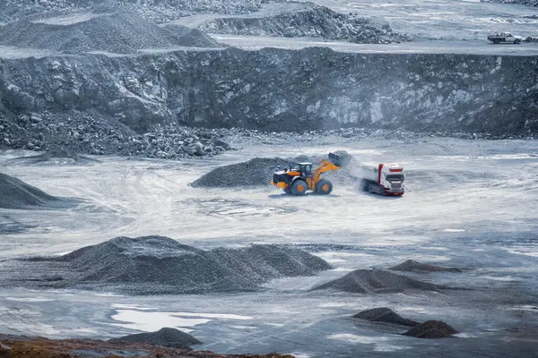 stock image Loader filling a dump truck in an expansive diabase quarry. Parekklisia, Cyprus