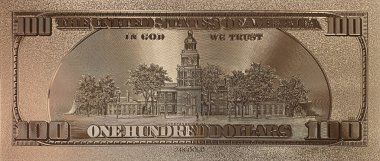 Altının üzerine basılan para arkadan gösteriliyor