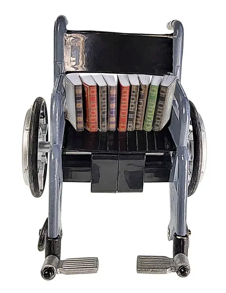 stock image Set of Books in a Wheelchair to research a medical issue