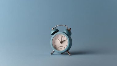 Alarm clock over a blue solid colour background